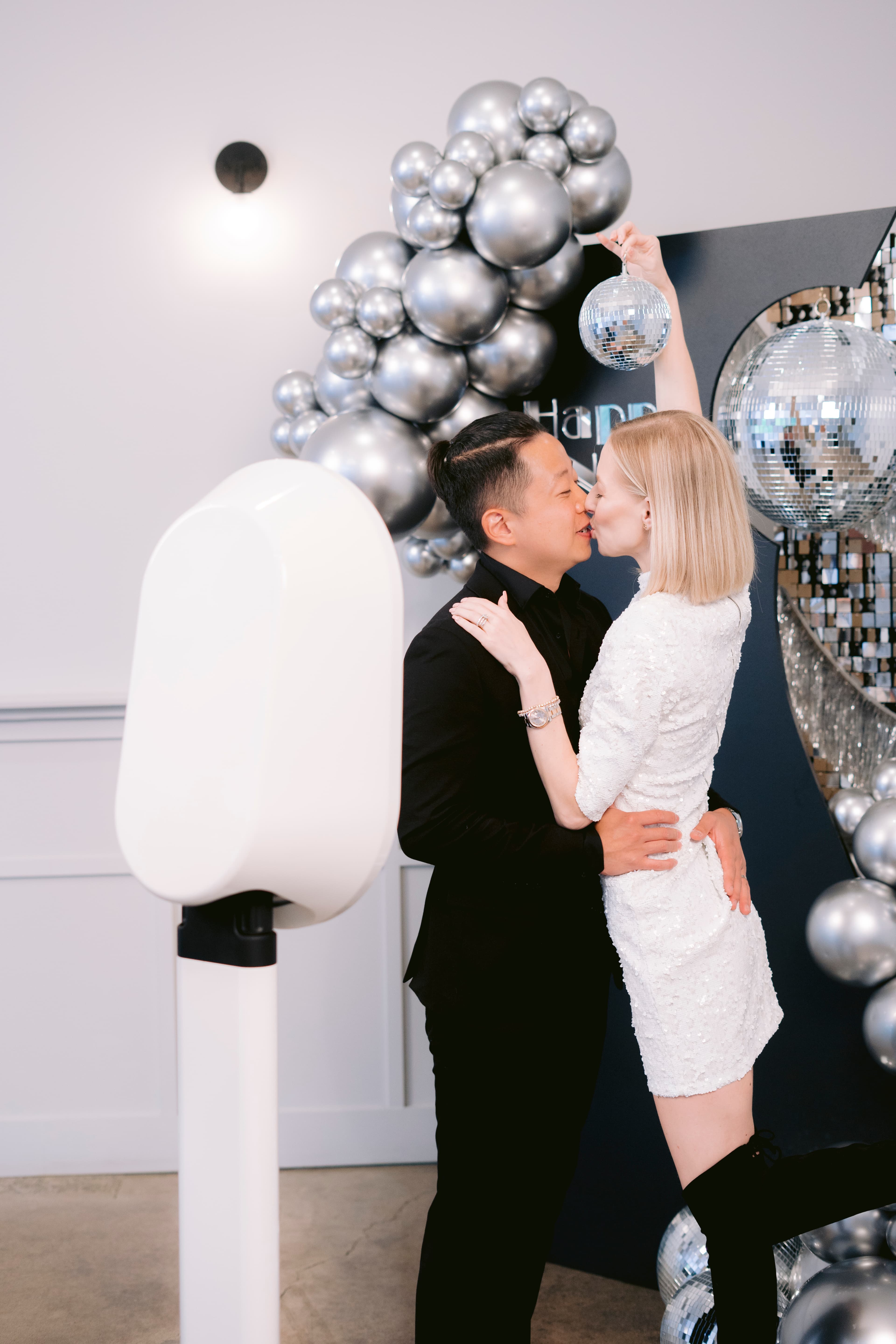 Couple posing at the Luxpiq photo booth at a New Year's Eve party