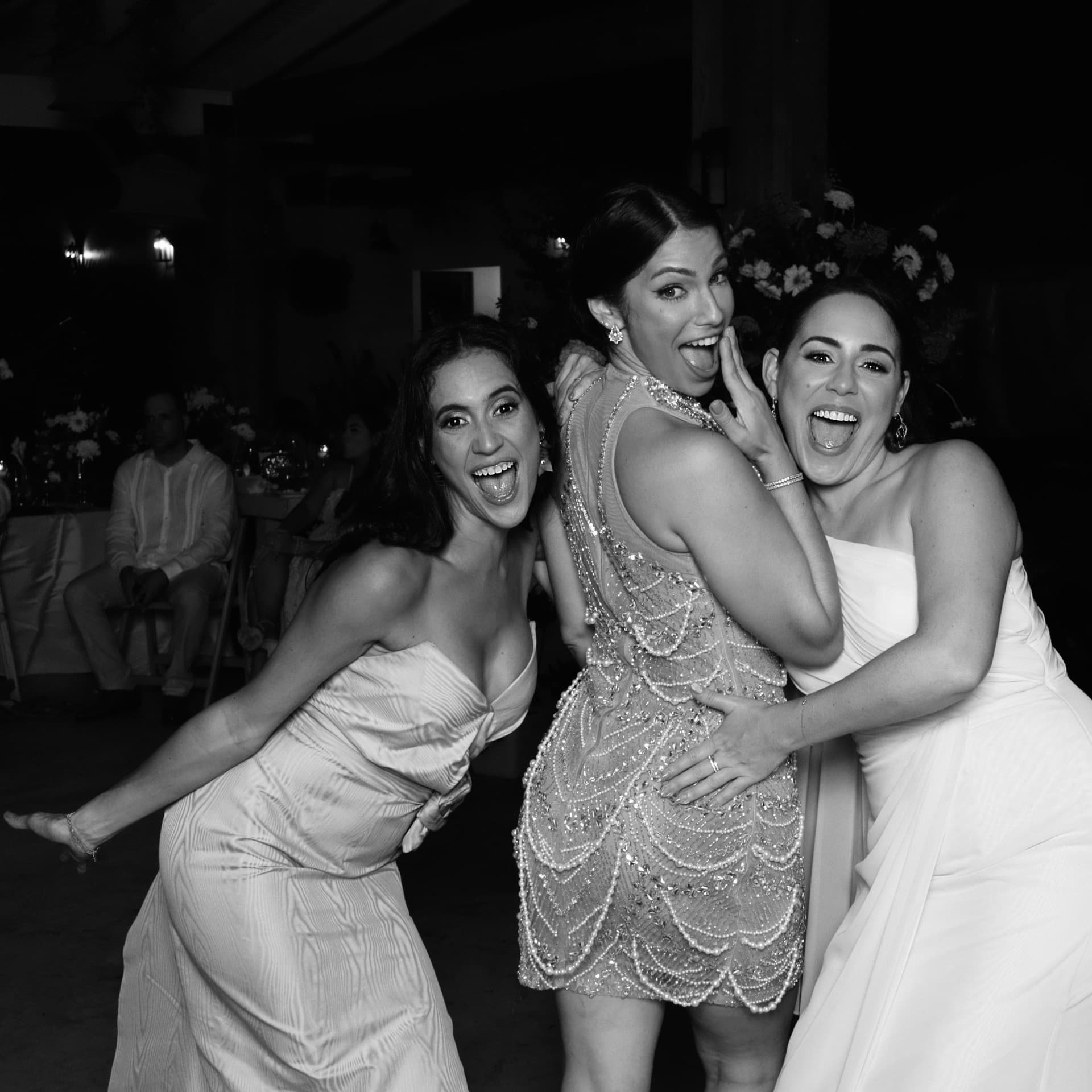 Wedding guests having fun at the Luxpiq photo booth at an evening reception